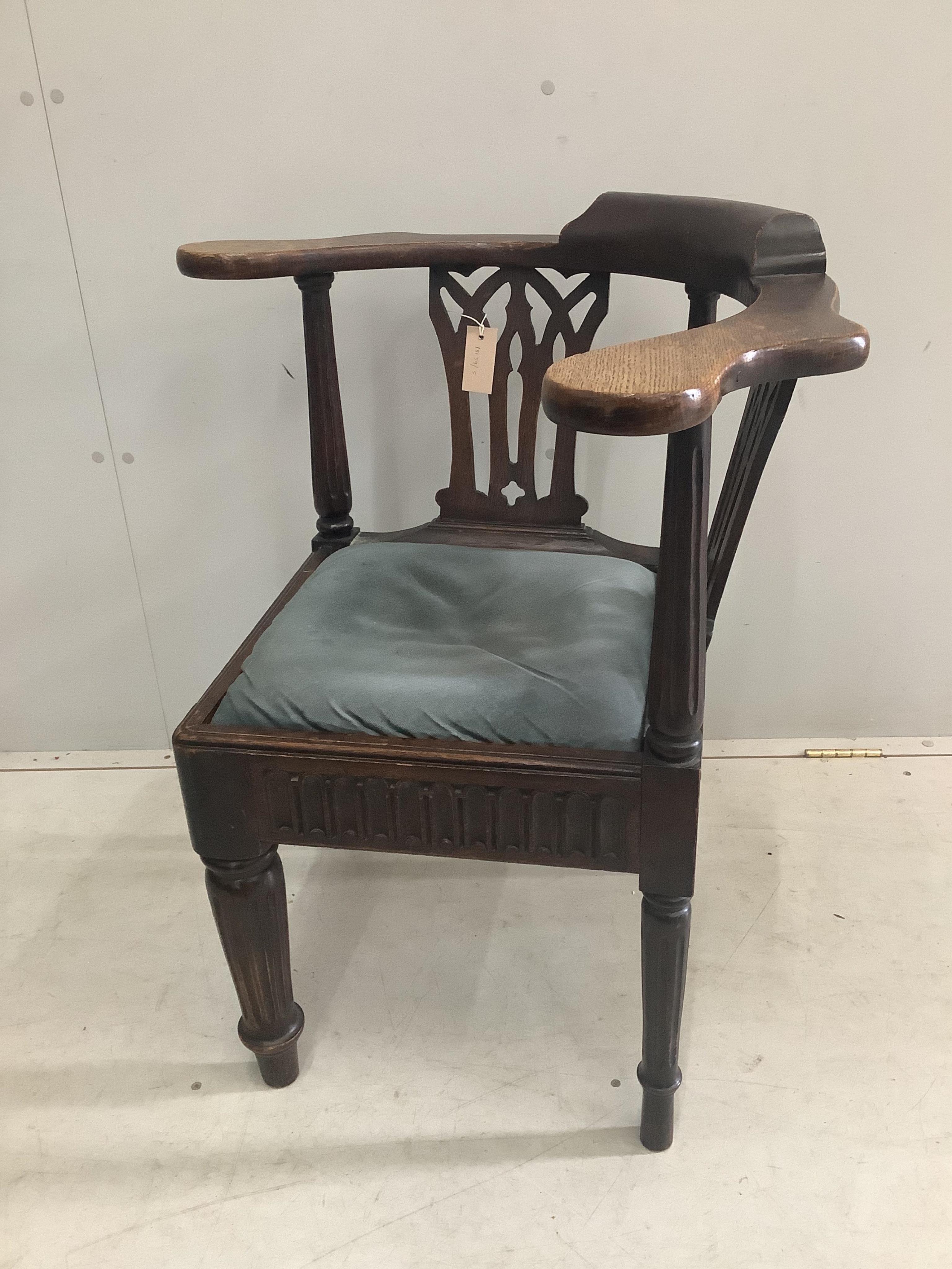 A George III oak corner elbow chair, width 72cm, depth 60cm, height 81cm